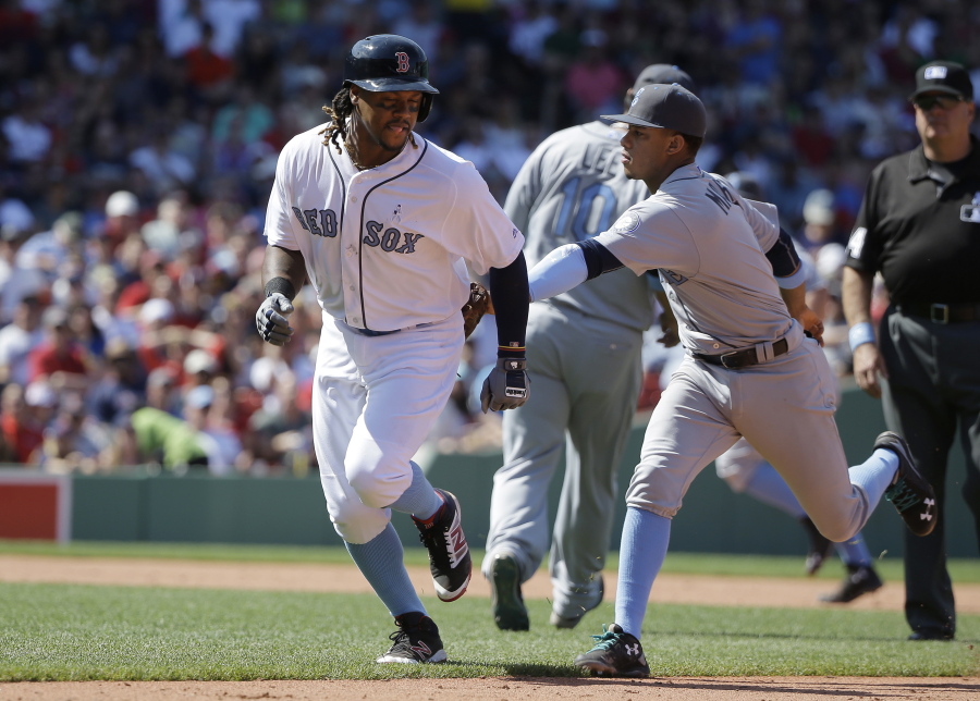 Boston Red Sox&#039;s Hanley Ramirez, left, is tagged out by Seattle Mariners&#039; Ketel Marte, right, in a rundown in the sixth inning of a baseball game, Sunday, June 19, 2016, in Boston.
