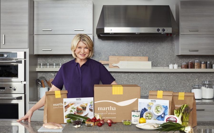 Martha Stewart poses with ingredients from a meal kit.