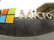 The Microsoft Corp. logo outside the Microsoft Visitor Center in Redmond, Wash. Microsoft said Monday, June 13, 2016, it is buying professional networking service site LinkedIn for about $26.2 billion. LinkedIn, based in Mountain View, Calif., has more than 430 million members. (AP Photo Ted S.
