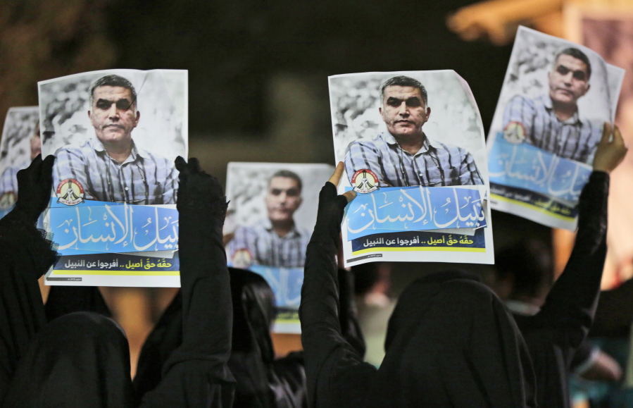 Bahraini anti-government protesters hold up images of jailed human rights activist Nabeel Rajab during a solidarity protest outside his home in Bani Jamra, Bahrain. A prominent activist in Bahrain has been detained by authorities after a raid on his home.