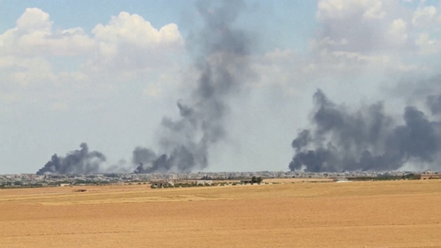 Smoke rises from the city of Manbij, Syria. U.S.-backed fighters on Thursday closed all major roads leading to the northern Syrian town of Manbij, a stronghold of the Islamic State group, and surrounded it from three sides, officials and Syrian opposition activists said. The town is one of the largest areas held by IS in the northern Aleppo province.