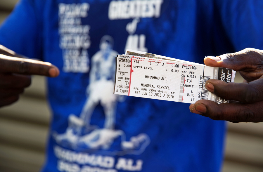 Montez Jones, of Louisville, shows off his tickets to Muhammad Ali&#039;s memorial service Friday at the KFC Yum! Center after waiting in line Wednesday, June 8, 2016, in Louisville, Ky. Ali&#039;s memorial service Friday looms as one of the most historic events in Louisville&#039;s history.