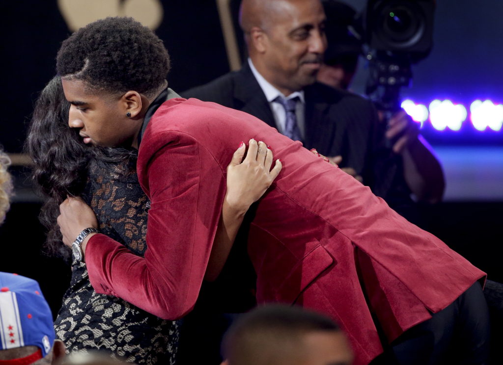 Marquese Chriss hugs a supporter after being selected eighth overall by the Sacramento Kings during the NBA basketball draft, Thursday, June 23, 2016, in New York.