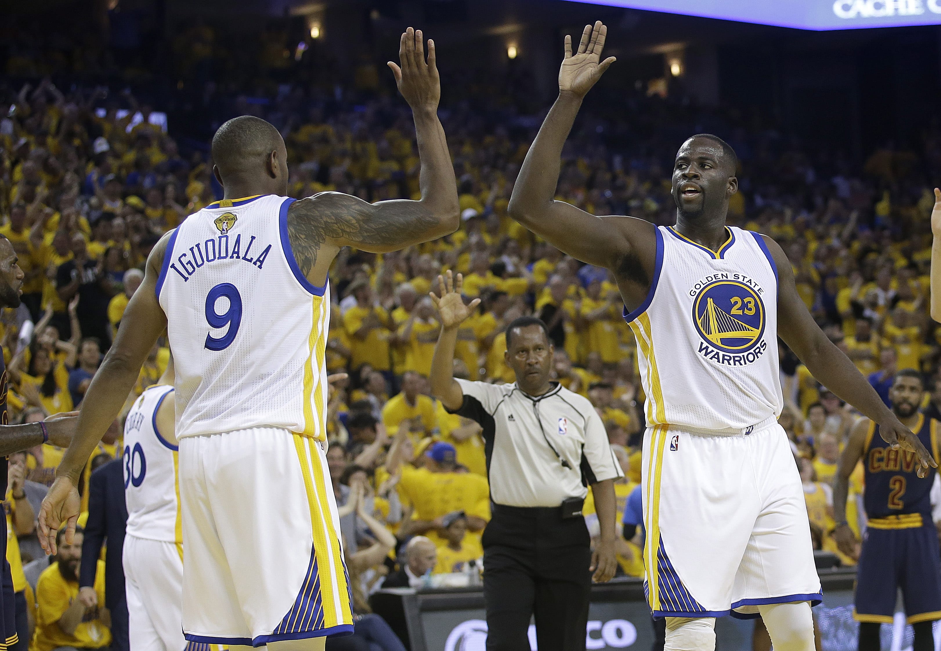 Golden State Warriors forward Draymond Green (23) and forward Andre Iguodala (9) celebrate during the first half of Game 2 of basketball's NBA Finals between the Warriors and the Cleveland Cavaliers in Oakland, Calif., Sunday, June 5, 2016.