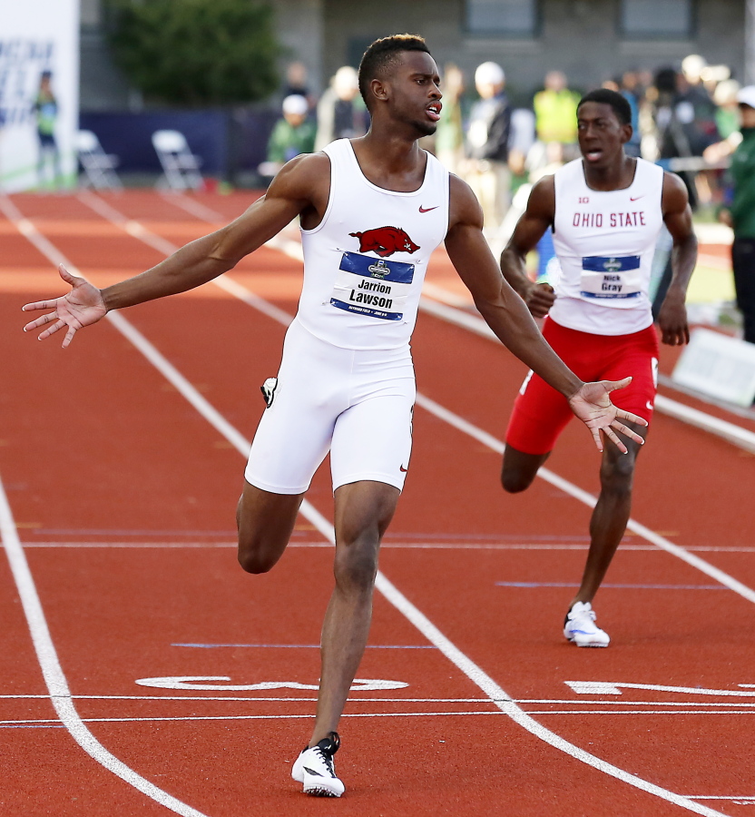 Arkansas&#039; Jarrion Lawson, left, wins the men&#039;s 200-meter dash at the NCAA outdoor track and field championships in Eugene, Ore., Friday, June 10, 2016.