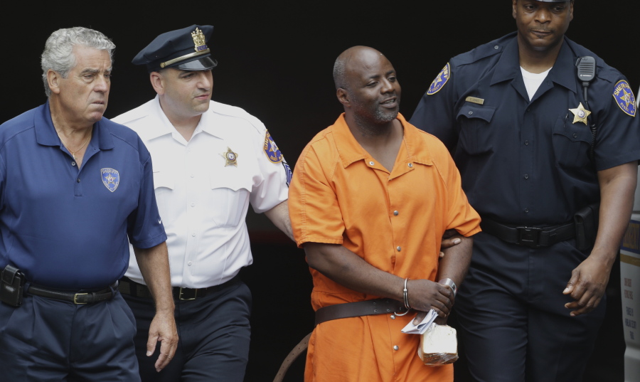 Shawn Custis, center right, is escorted from an arraignment hearing by Sheriff Armando Fontoura, left, Sgt. Marco Vulpi, center left, and sheriff&#039;s officer Curtis Jones, right, at Essex County Superior Court in Newark, N.J. Custis was sentenced to life in prison on June 29, following his conviction in a 2013 home invasion beating in Millburn, N.J., that was caught on a nanny cam.