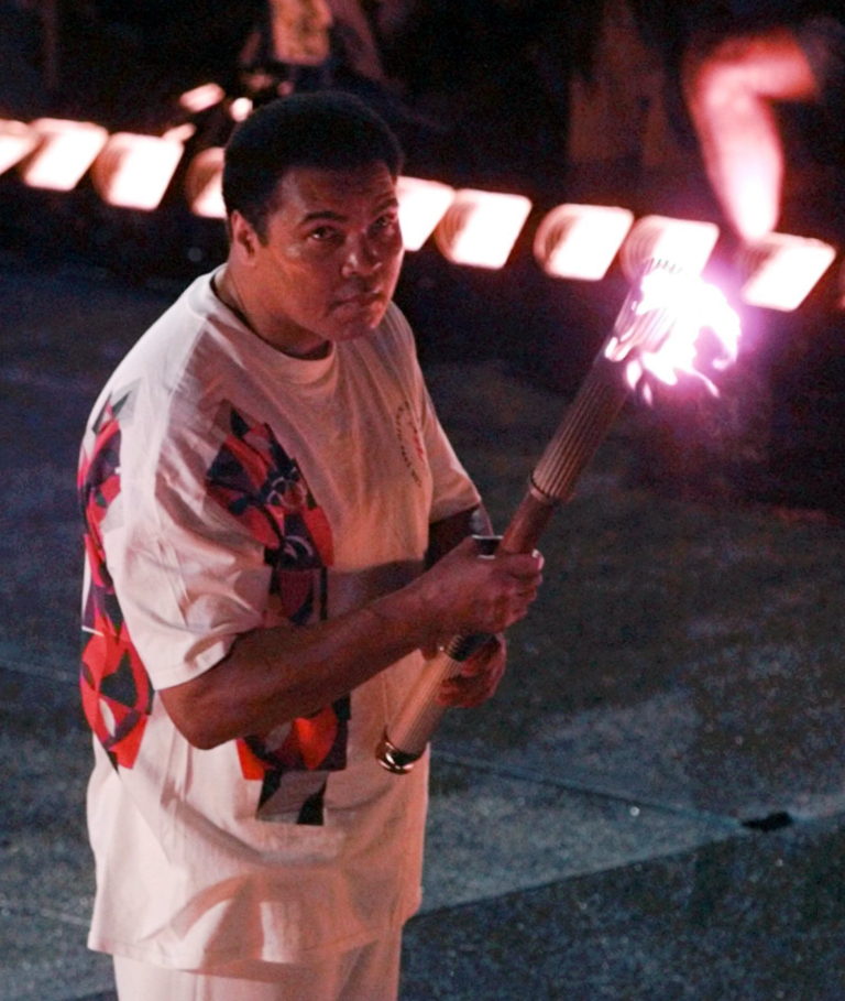 Muhammad Ali watches as the flame climbs up to the Olympic torch during the opening ceremonies of the Summer Olympics, in Atlanta on July 19, 1996.