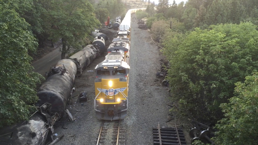 Crumpled oil tankers lying beside the railroad tracks after a fiery train derailment on June 3  that prompted evacuations from the tiny Columbia River Gorge town about 70 miles east of Portland in Mosier, Ore. Union Pacific said Wednesday that it will resume running oil trains through the Gorge.