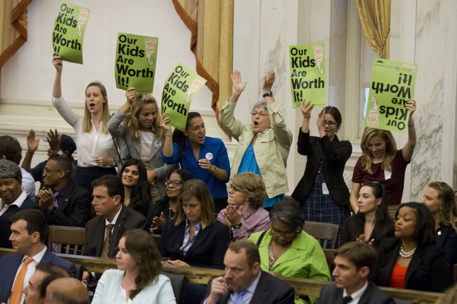 Audience members cheer Thursday after the Philadelphia City Council passed a tax on sugary and diet sodas.