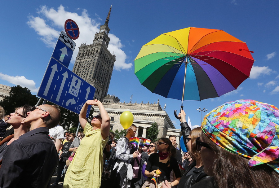 People with rainbow-colored items walk in an Equality Parade to show their support for sexual minority groups Saturday in Warsaw, Poland.