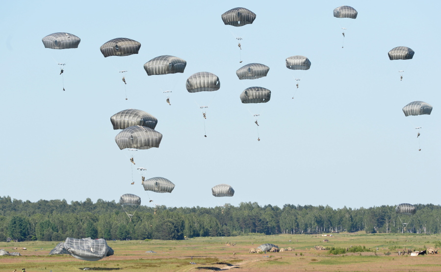 Soldiers from the U.S. 82nd Airborne Division jump with soldiers and equipment from  Great Britain and Poland onto a designated drop zone Tuesday near Torun, Poland.