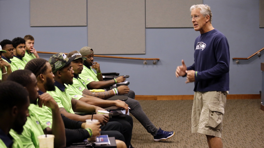Seattle Seahawks coach Pete Carroll talks with rookies at the football team&#039;s training camp Monday in Renton. The team is holding a rookie symposium.