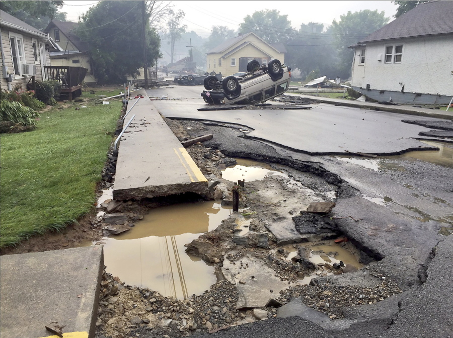 A vehicle rests on the roof Friday after flooding near White Sulphur Springs, W.Va. Multiple fatalities have been reported in flooding that has devastated parts of the state, a state official said Friday morning. The fatalities included at least one child and one adult.