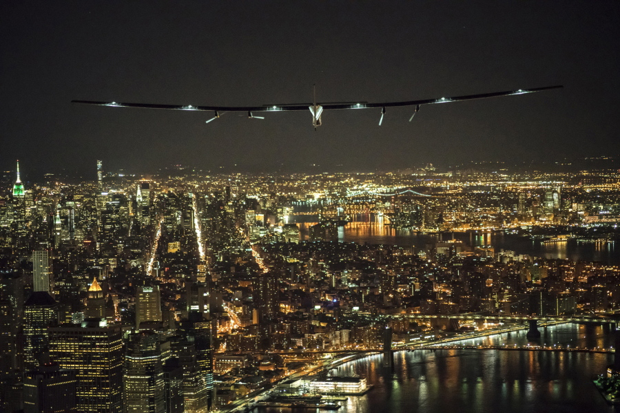 In this photo released by Jean Revillard/ SI2, solar-powered airplane Solar Impulse 2, piloted by Swiss adventurer Andre Borschberg, flies over Manhattan in New York Saturday, June 11, 2016 shortly before landing at John F. Kennedy International Airport. The Swiss-made Solar Impulse 2 has landed in New York City on the latest leg of its globe-circling voyage. It had left Lehigh Valley International Airport in Pennsylvania late Friday.