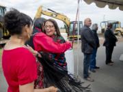 In this June 8, 2016 photo, Spokane Tribal Business Council chair Carol Evans, center, hugs council member Dave BrownEagle after the celebration of the tribe getting final approval from Gov. Jay Inslee for the tribe's long-planned casino at the corner of Craig Rd. and Highway 2 in Spokane, Wash. At far left is Norah RedFox BrownEagle, David BrownEagle's wife. Standing at right are council members Greg Abrahamson, third from right, Glenn Ford, second from right, and Kanny Kieffer, right.