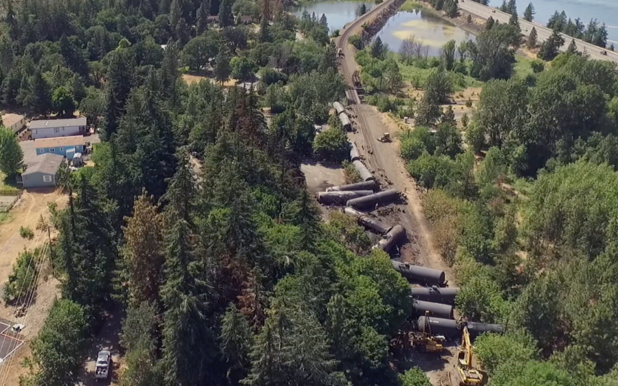 This video image taken from a drone shows an aerial view of crumpled oil tankers lying beside the railroad tracks after a fiery train derailment on June 3 prompted evacuations from the tiny Columbia River Gorge town about 70 miles east of Portland on June 6  in Mosier, Ore. The Union Pacific train derailment comes as a massive oil-storage terminal proposed along the Columbia River in southwest Washington is under review.