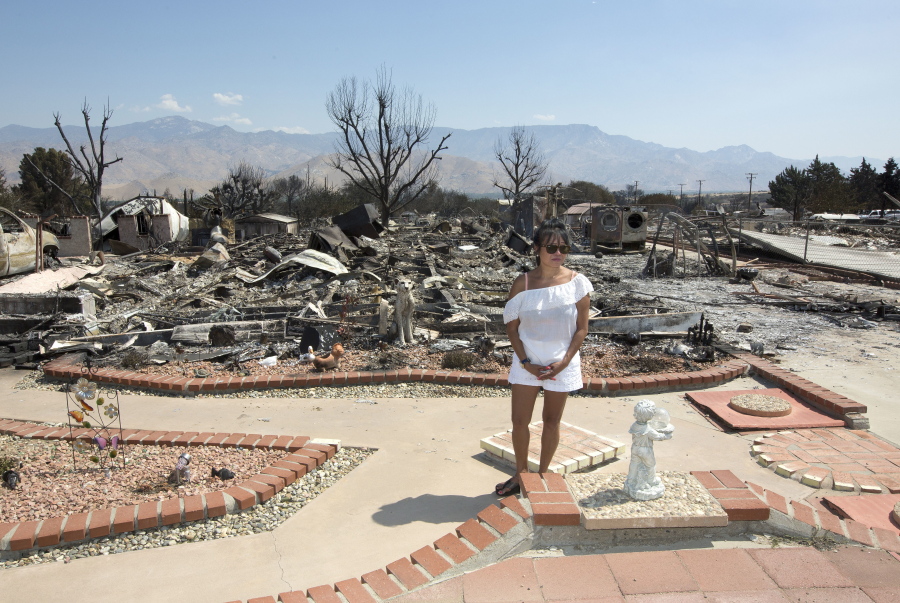Genoveva Gibson turns away from the burned-out ruins of her home Monday in South Lake, Calif. Gibson returned to her home to search for her missing dogs that were at the house when fire swept through the area.