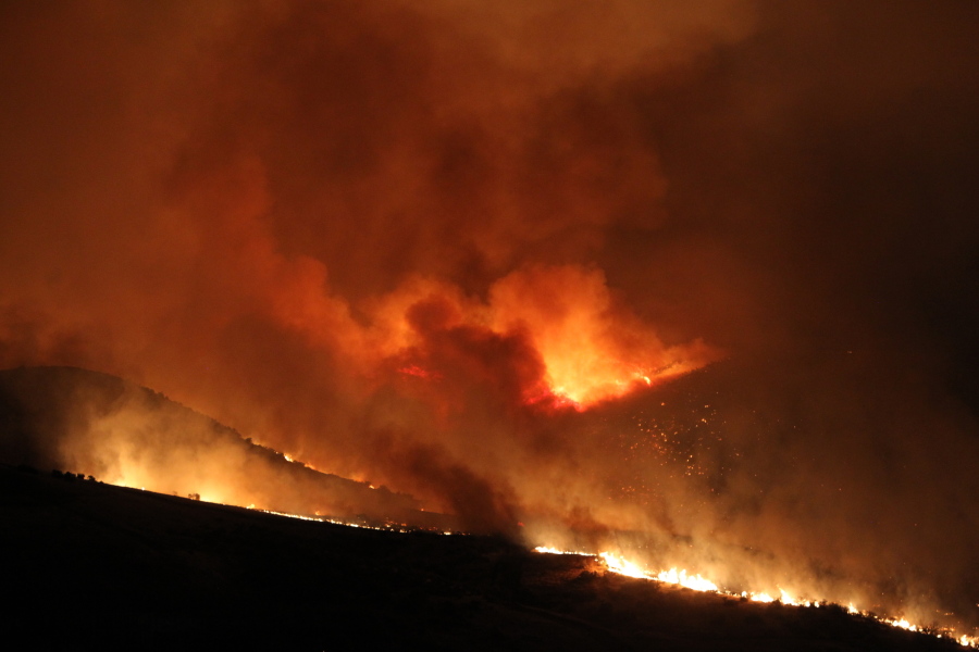 A wildfire fire burns early Thursday near Table Rock in Boise, Idaho.