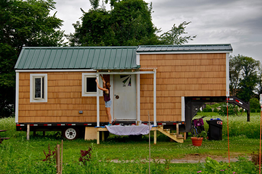 Sarah Hastings paints the porch of her 190-square-foot tiny house in Hadley, Mass., before being cited for breaking zoning laws. In many places, it&#039;s still a struggle to live legally in tiny houses.