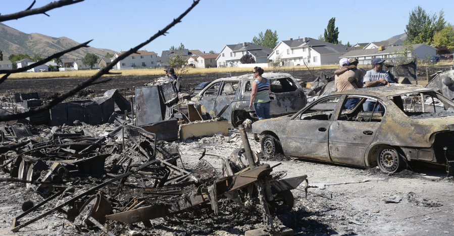 Tooele, Utah, residents survey the damage at a burned-out mobile home park. Ten homes were destroyed.