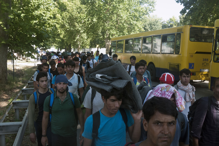 Migrants walk Friday on the outskirts of Belgrade, Serbia toward Serbia&#039;s border with Hungary.
