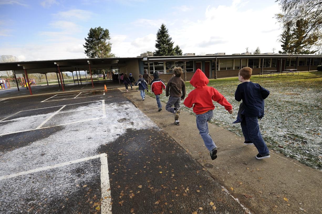 Students run on their way back to class after lunch at Glenwood Heights Primary School in 2010. Glenwood Heights is one of the schools that would be replaced if the $80 million bond is passed in November.