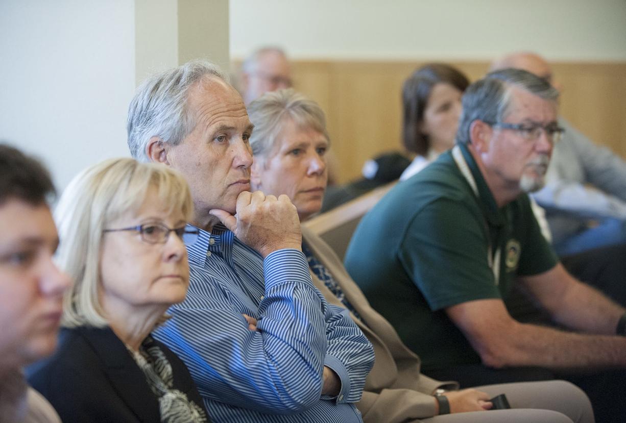 Clark County council members Jeanne Stewart, from left, Marc Boldt and Julie Olson listen to court proceedings with County Manager Mark McCauley on July 29. Visiting Cowlitz County Judge Stephen Warning heard and cleared the three councilors of allegations made against them in a recall petition by fellow Councilor Tom Mielke.