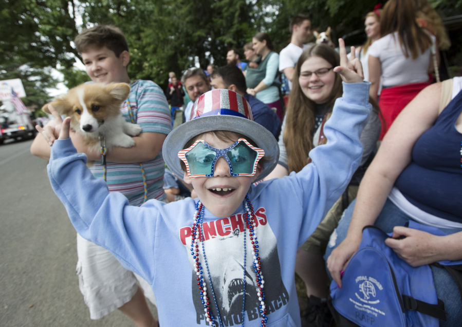 Connor Rapp reacts to getting candy from passing floats at the Fourth of July Parade in Ridgefield Monday.