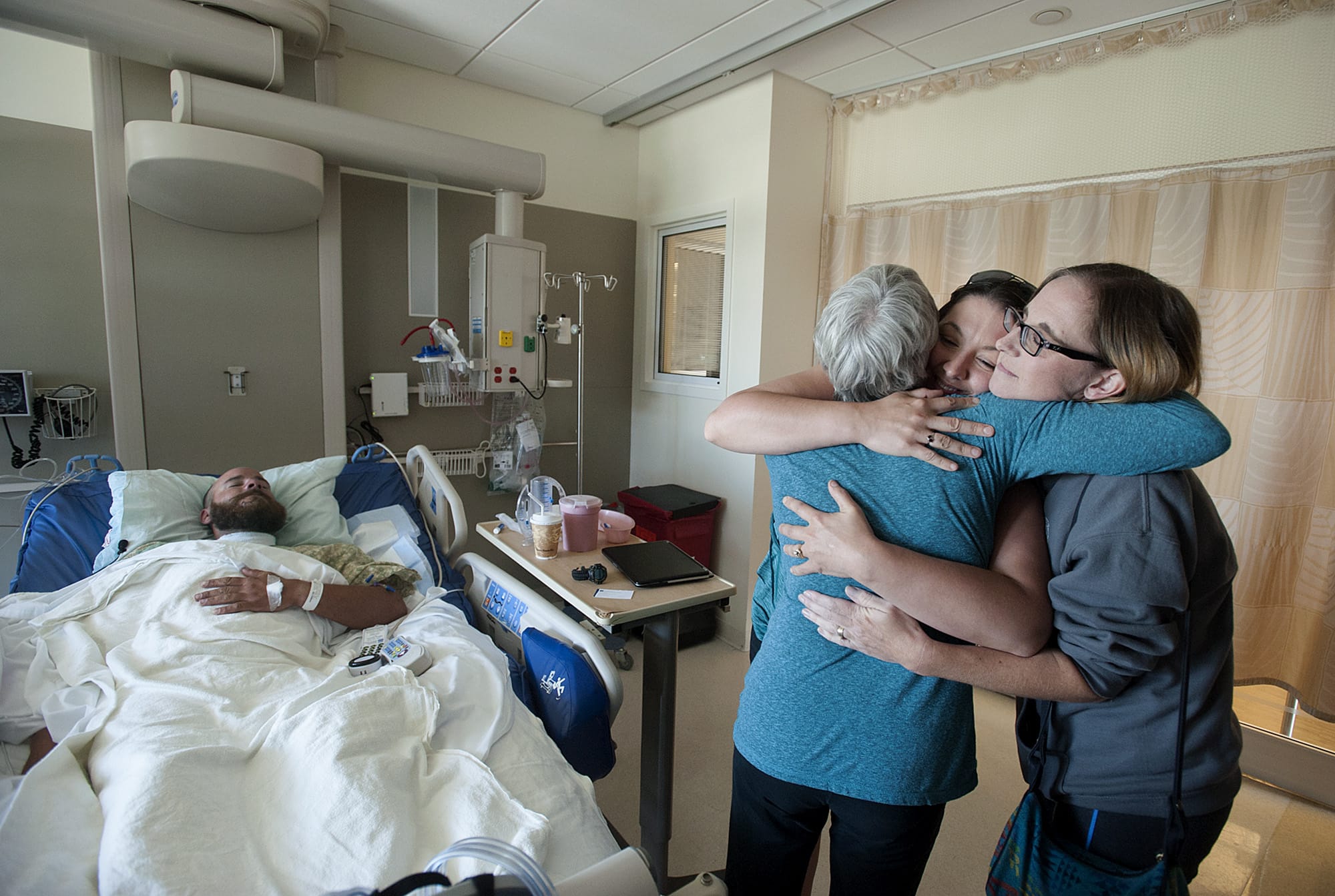Scott Jensen of Amboy, from left, rests in his hospital bed as his mom, Therese Jensen, thanks the women who helped save his life, Hiedi Poulson of Brush Prairie and Kim Detter of Battle Ground, Wednesday morning, July 6, 2016 at PeaceHealth Southwest Medical Center.