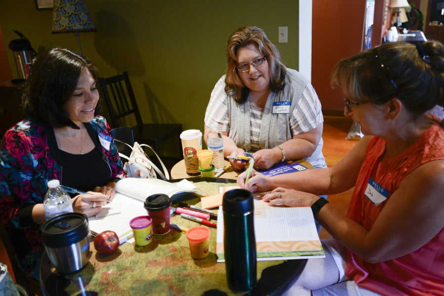 From left, Aideet Pineda, Kerri Upton and Deb Dwonch discuss behaviors of typical adolescents last month in a youth mental health first aid training course at Starting Grounds Church in Battle Ground.