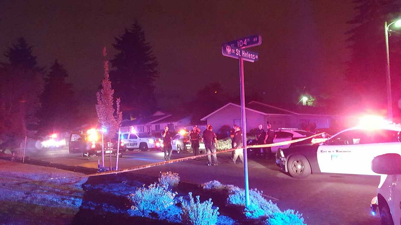 Vancouver police officers and Clark County sheriff's deputies respond Sunday night in east Vancouver following a pursuit where the suspect driver allegedly dragged a deputy around a Wal-Mart parking lot and drove into oncoming traffic while trying to elude police.