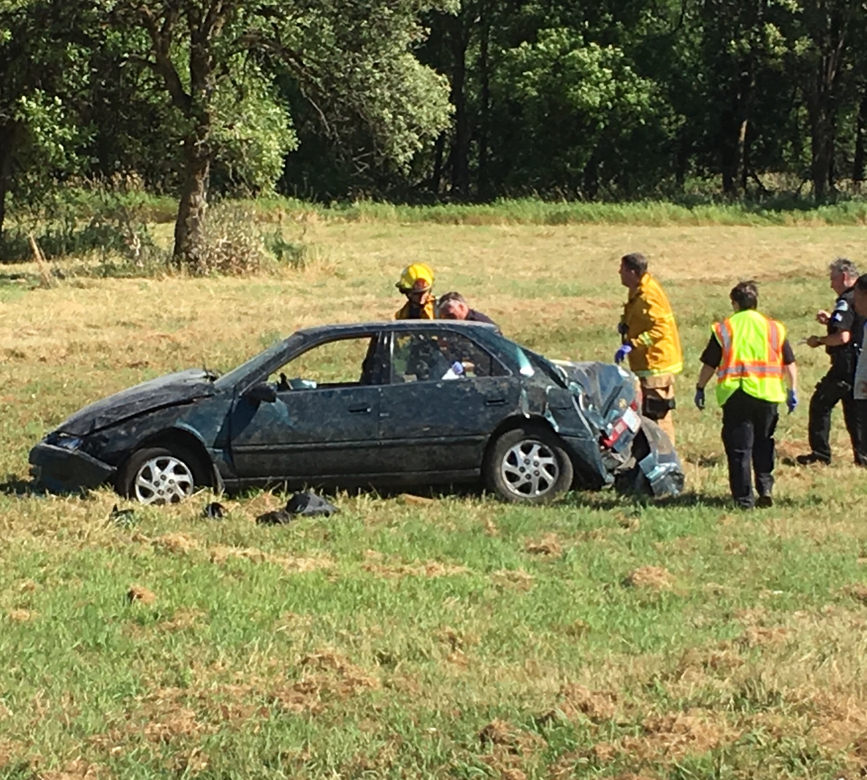 Police and firefighters respond Thursday afternoon at the Ridgefield Wildlife Refuge after an end-over-end rollover crash that left at least one occupant of this car with serious injuries.