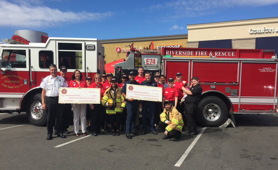 Brush Prairie: Members of Fire District 3 with Riverside Fire and Rescue and representatives from Firehouse Subs Public Safety Foundation, which donated a heart monitor and defibrillator to District 3.