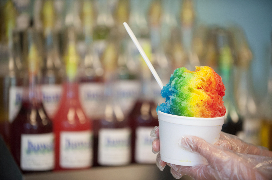 A shaved ice with cherry, banana and blue raspberry flavors is displayed at Megan&#039;s Snack Shack.