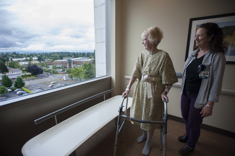 Betty Shrum of Vancouver, left, and physical therapist Brenda Powell check out the sixth-floor view Friday morning during a walk around the Thomas and Sandra Young Neurosciences Center at PeaceHealth Southwest Medical Center.