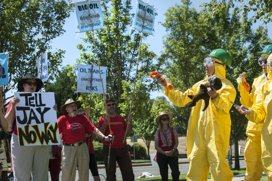Tara Herberger wore a hazmat suit and carried an oil-stained wolf stuffed animal during a protest over the proposed oil terminal on the final day of adjudication hearings Friday at Clark College Technical Center. With the trial-like hearings concluded, the Energy Facility Site Evaluation Council will issue a recommendation to the governor, possibly later this year, whether to approve or deny the Vancouver Energy terminal project.