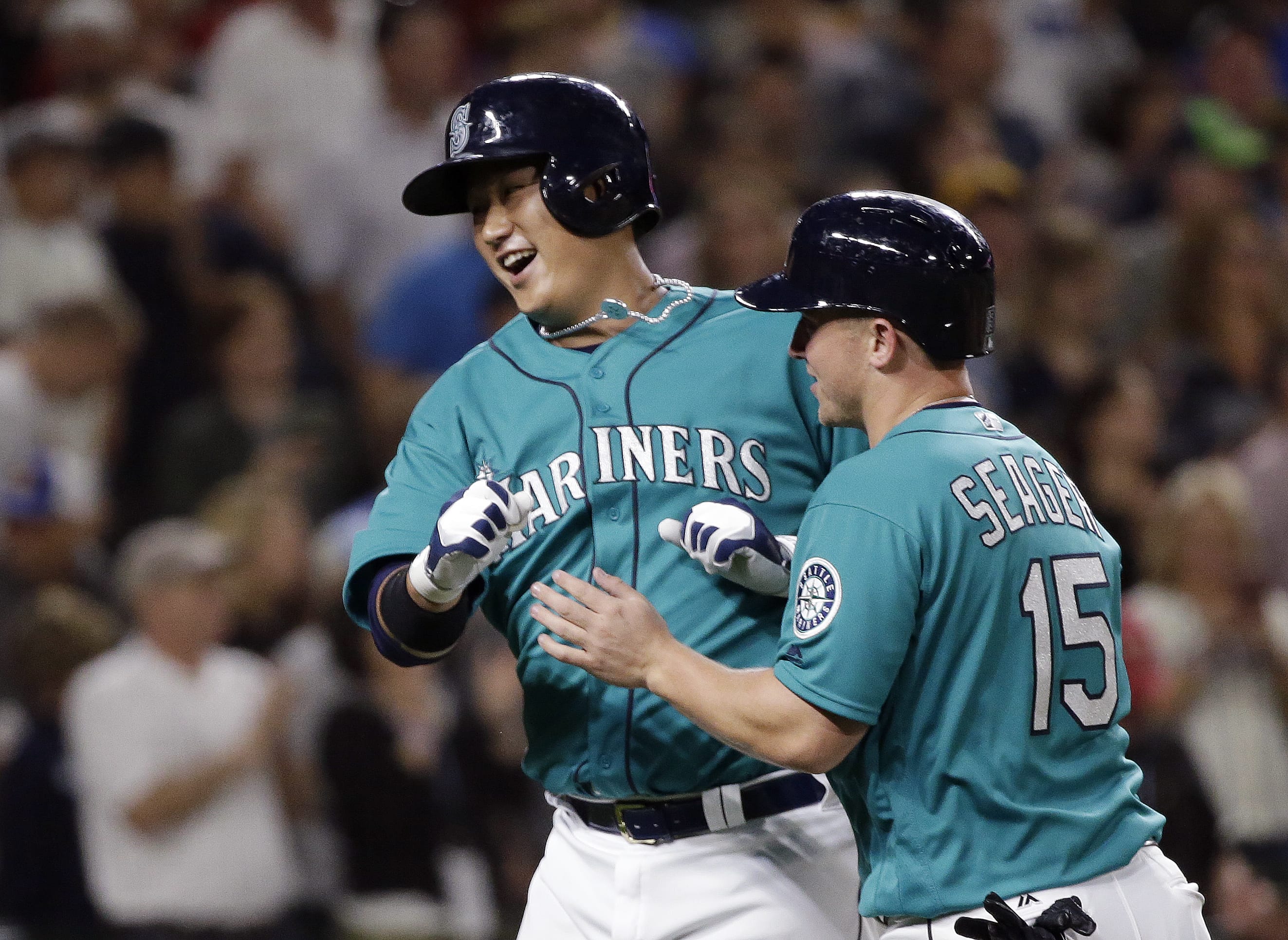 Seattle Mariners' Dae-Ho Lee, left, is met at home by Kyle Seager on his two-run home run against the Baltimore Orioles during the eighth inning of a baseball game Friday, July 1, 2016, in Seattle. The Mariners won 5-2.