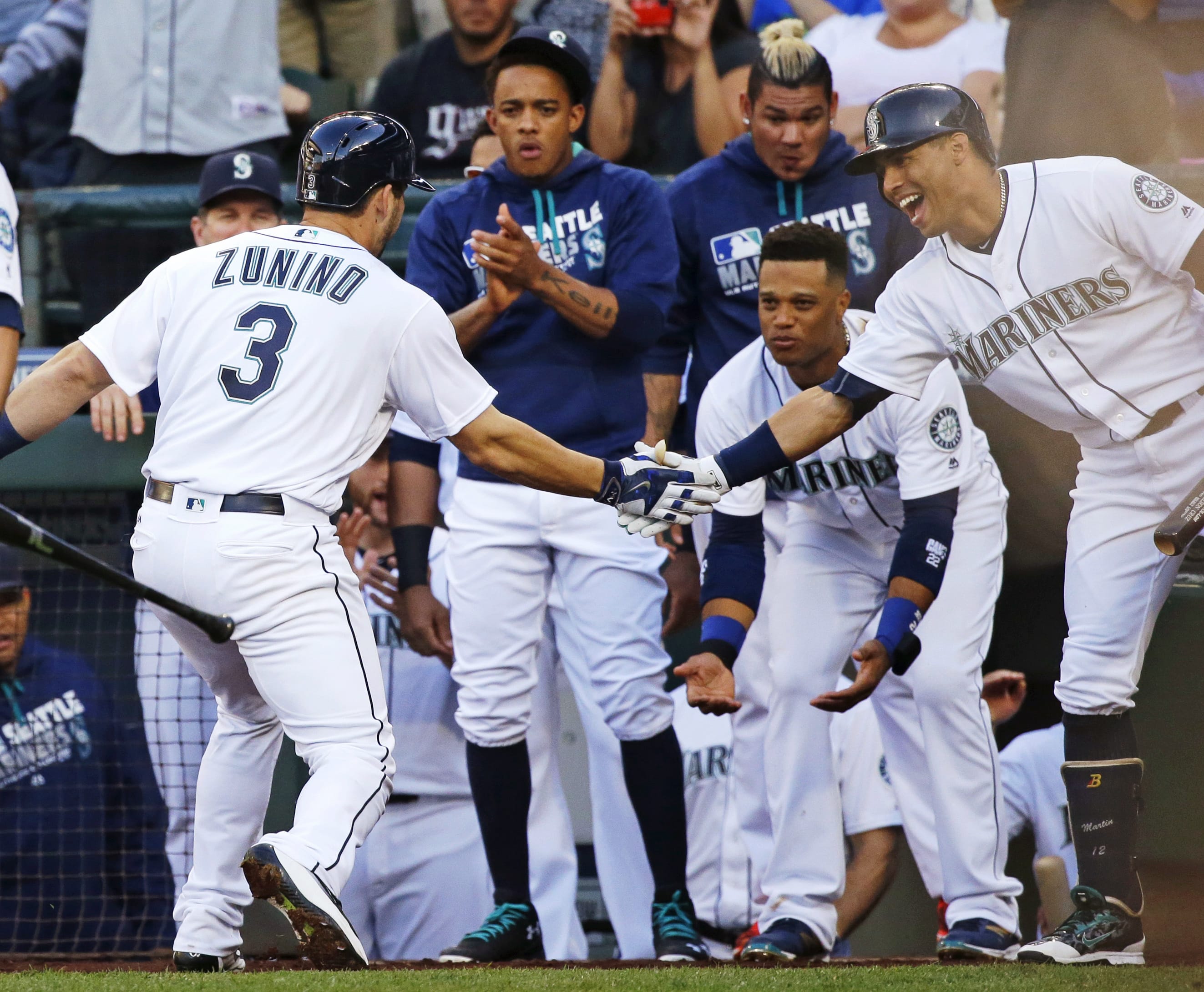 Seattle Mariners' Mike Zunino (3) is greeted at the dugout by teammates after he hit a two-run home run against the Baltimore Orioles during the second inning of a baseball game, Saturday, July 2, 2016, in Seattle. (AP Photo/Ted S.