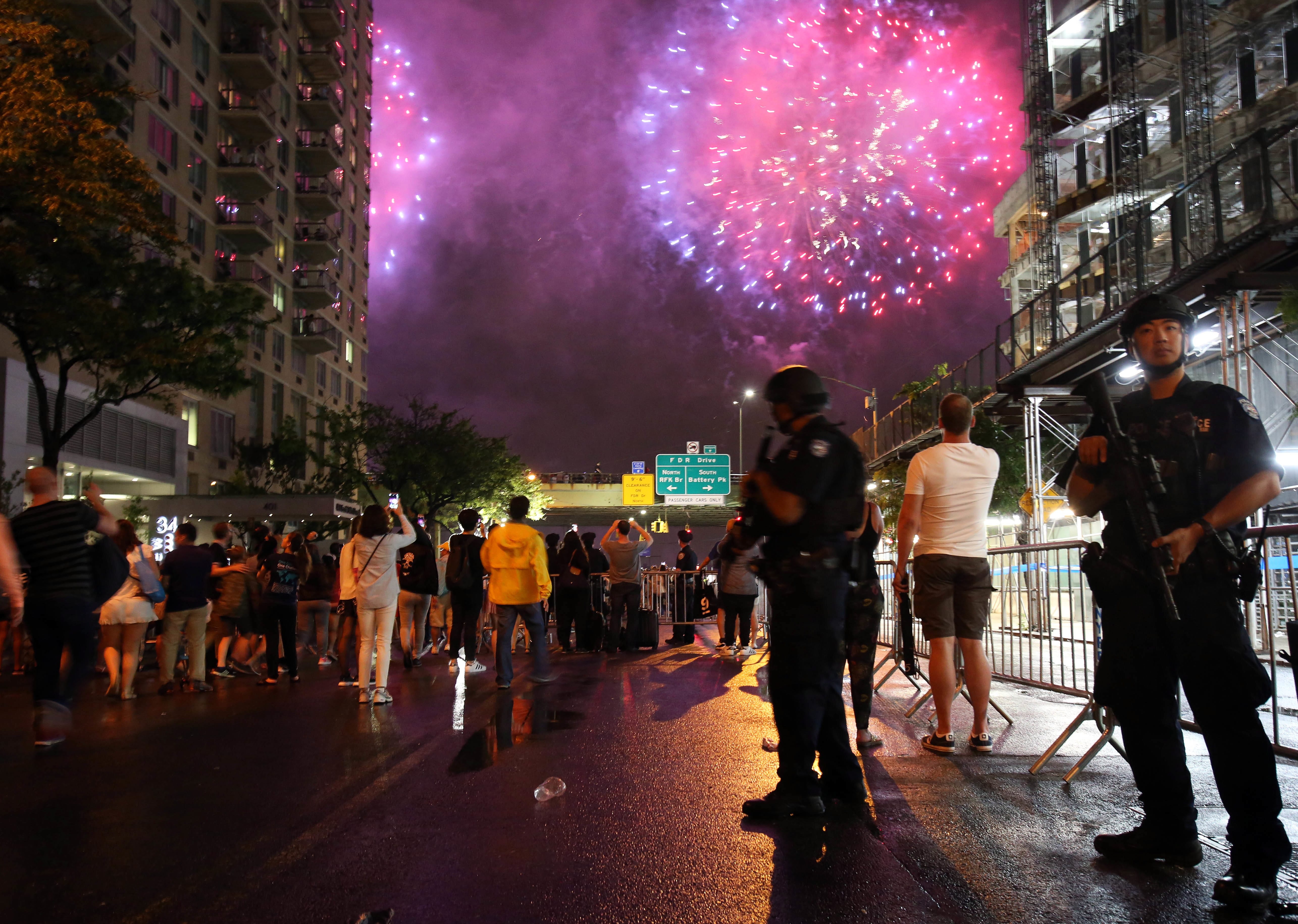 New York City counterterrorism police officers watch over spectators watching the Fourth of July fireworks, Monday, July 4, 2016, along the East River on the FDR Drive in New York.