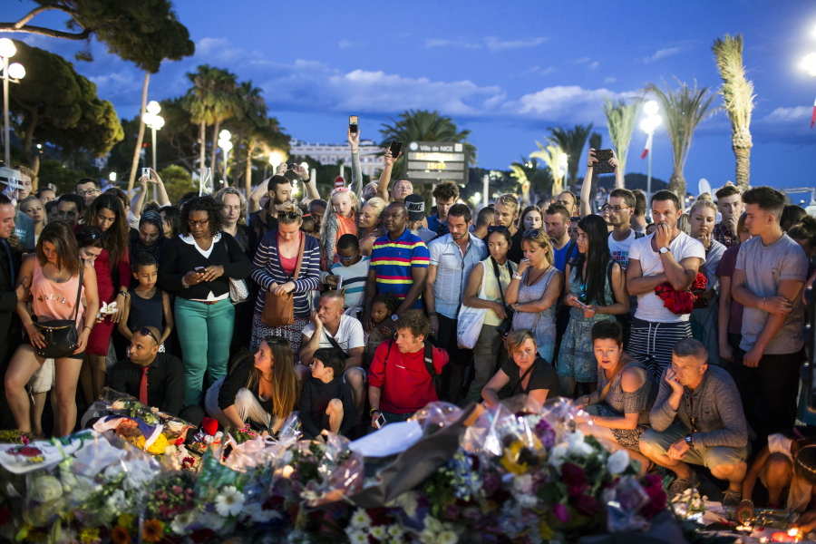 People gather at a makeshift memorial to honor the victims of Thursday night&#039;s attack,  on Friday near the area where a truck mowed through revelers in Nice, southern France.