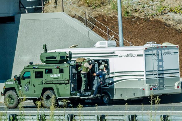 SWAT team members use an armored vehicle while investigating a stolen RV on northbound Interstate 205 on July 30. The investigation led to a 2.5-hour freeway closure.