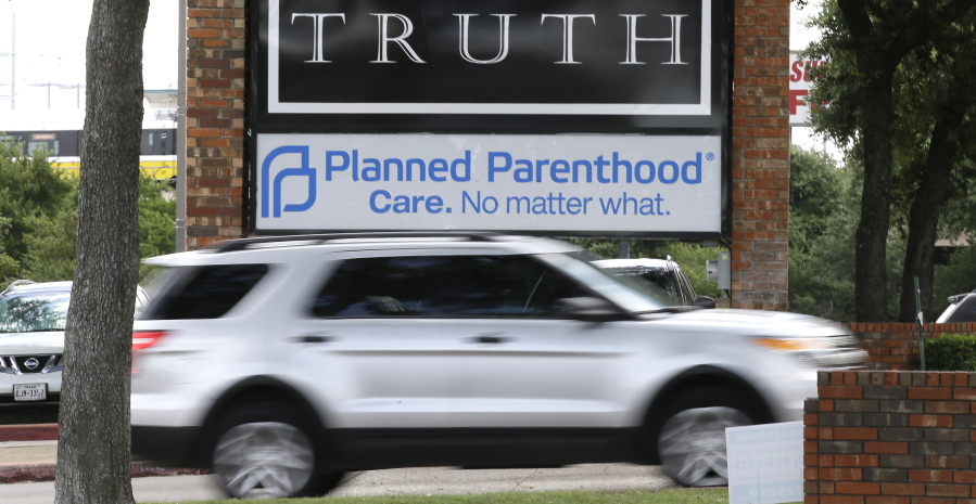 FILE - In a Monday, June 27, 2016 file photo, traffic passes a Planned Parenthood sign in Dallas. Abortions in Texas plummeted about 15 percent during the first year after approval of tough restrictions that the U.S. Supreme Court has since struck down ??? a decline that activists say shows how hard it had become to get an abortion in America&#039;s second-largest state. The health department released the statistics Thursday, June 30, 2016.