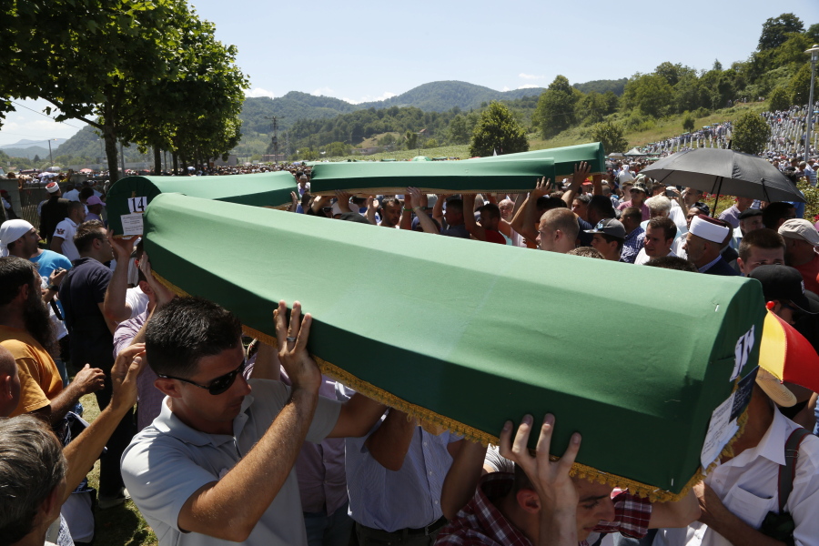 Bosnian people caring coffins during a funeral ceremony for the 127 victims at the Potocari memorial complex near Srebrenica, 94 miles northeast of Sarajevo, Bosnia and Herzegovina, on Monday.