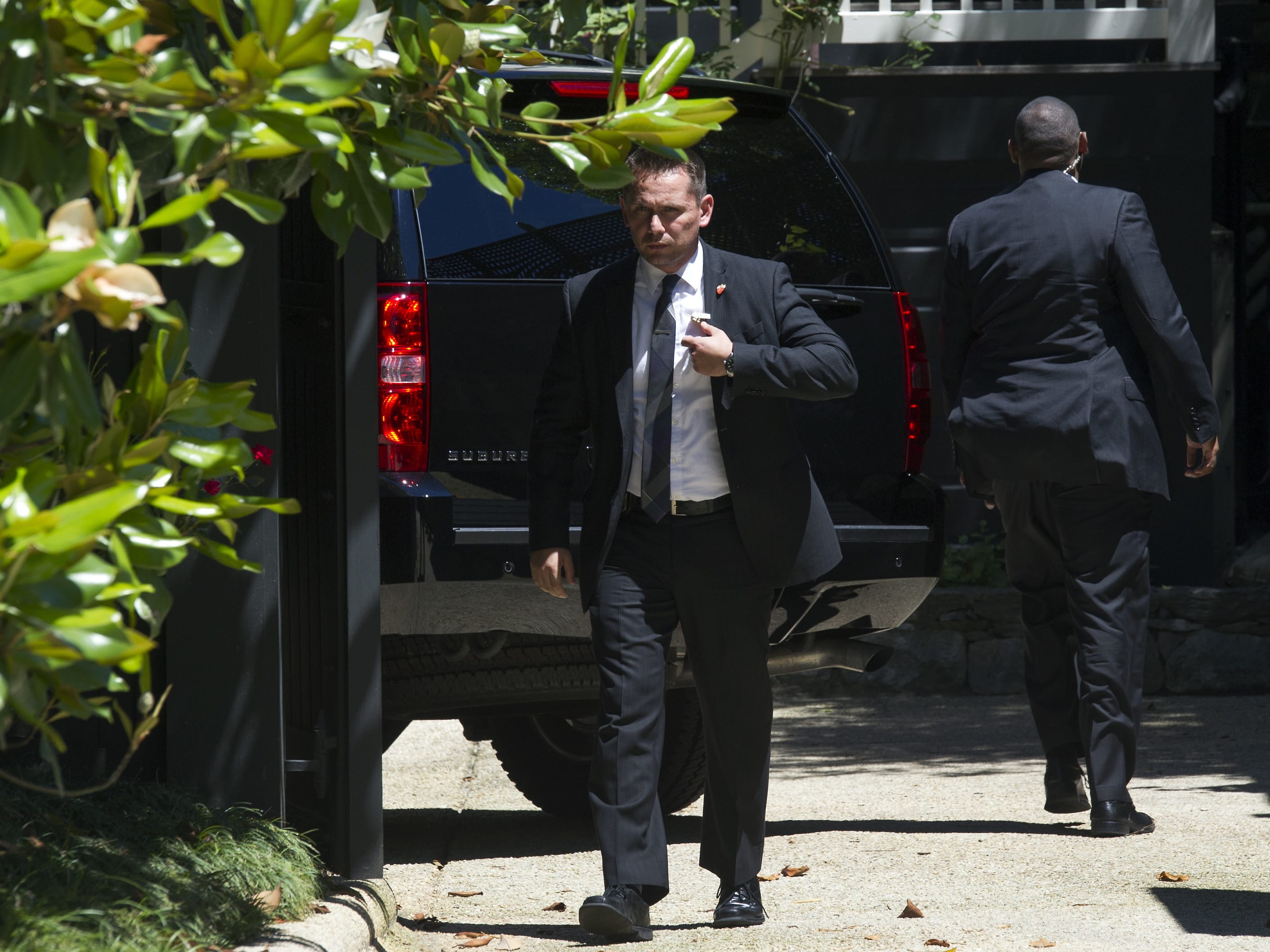 Secret Service stand guard around a Secret Service vehicle after it arrived at the home of Democratic presidential candidate Hillary Clinton in Washington, Saturday, July 2, 2016. The Clinton campaign says the FBI interviewed Clinton on Saturday morning in Washington, about her emails while she was secretary of state.