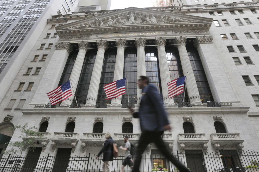 People walk by the New York Stock Exchange in June. Global stocks mostly rose Friday as authorities stepped in to ease the uncertainty surrounding the British vote to leave the European Union.