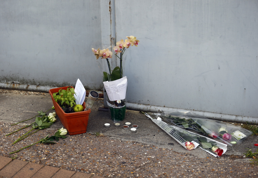 Flowers, candles and messages are placed at the home of Father Jacques Hamel after he was killed during an attack in a church, in Saint-Etienne-du-Rouvray, Normandy, France, on Tuesday. Two attackers invaded a church Tuesday during morning Mass near the Normandy city of Rouen, killing an 84-year-old priest by slitting his throat and taking hostages before being shot and killed by police, French officials said.