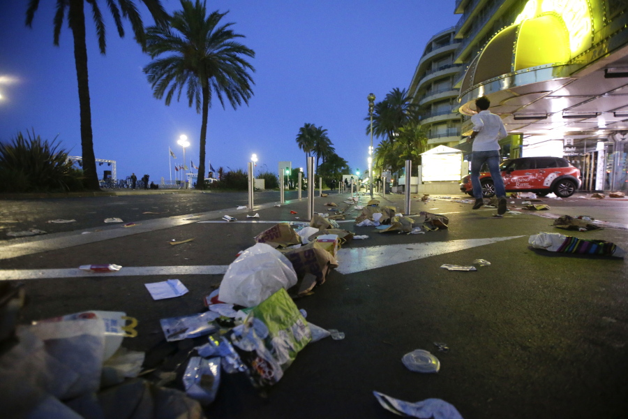 A man runs near where a truck drove onto the sidewalk, running over revelers who&#039;d gathered to watch fireworks in the French resort city of Nice.
