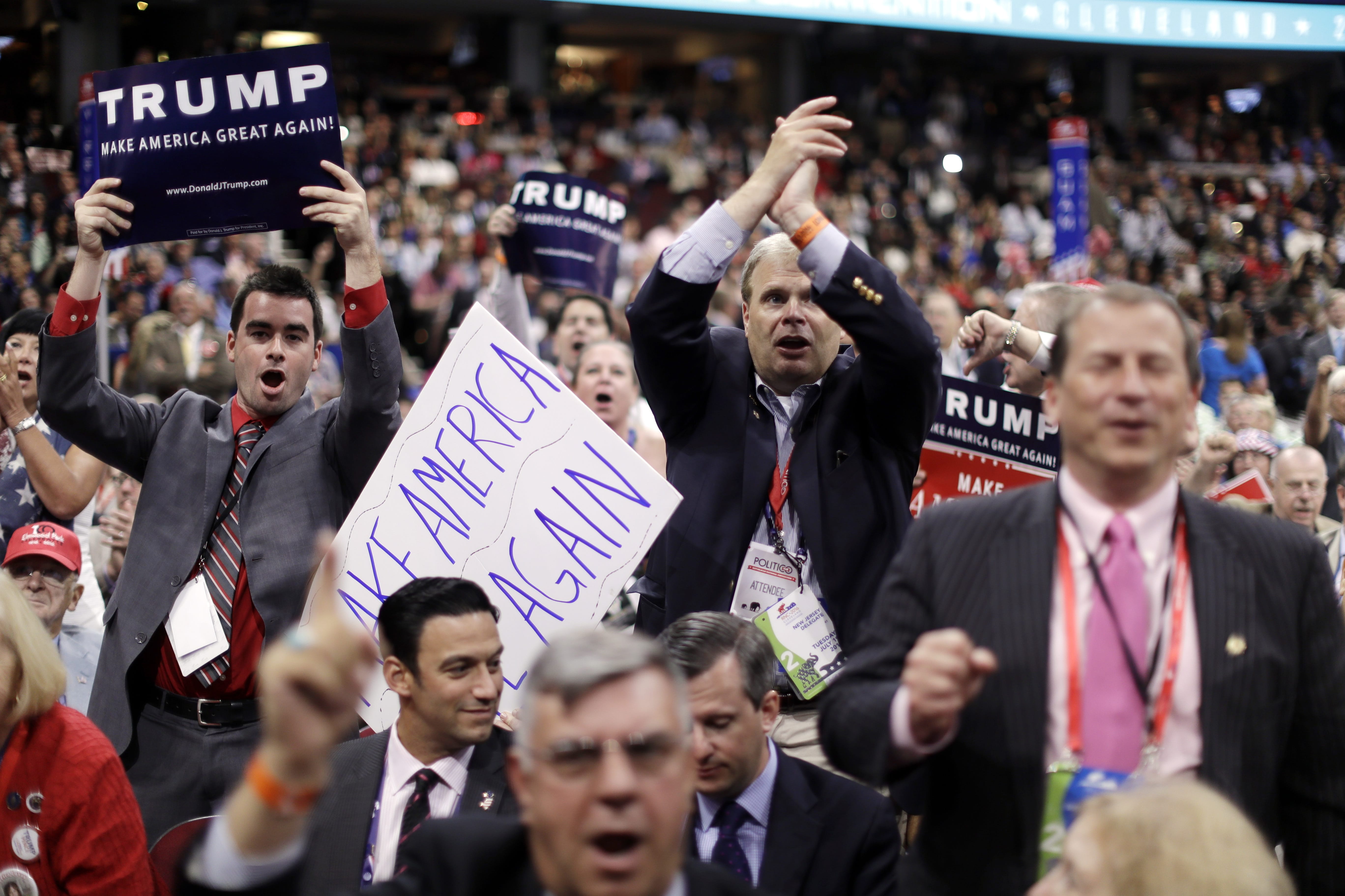 New Jersey delegates cheer as New Jersey Gov. Chris Christie speaks during the second day session of the Republican National Convention in Cleveland, Tuesday, July 19, 2016.