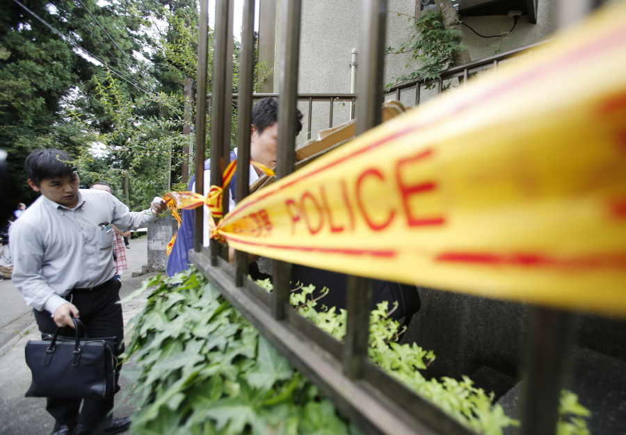 Police officers enter into the house of Satoshi Uematsu, the suspect in Tuesday&#039;s mass stabbing attack, in Sagamihara, outside of Tokyo, on Wednesday. The suspect was being transferred Wednesday from a local police station to the prosecutor&#039;s office in Yokohama.