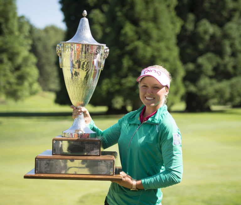 Brooke Henderson, of Canada, holds the championship trophy after winning the LPGA Cambia Portland Classic golf tournament Sunday, July 3, 2016, in Portland, Ore.